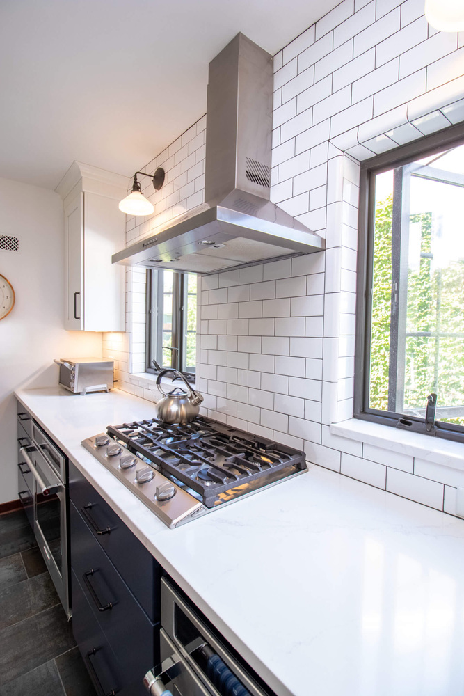 kitchen remodel with gas range and stainless vent hood by Odd Fellows Contracting in East Lansing MI