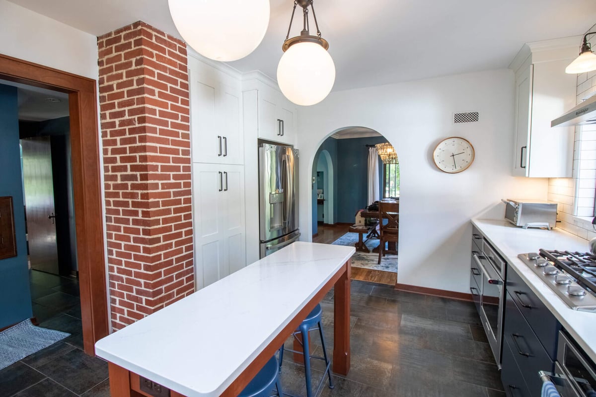 kitchen renovation with white cabinetry and brick accent column by Odd Fellows Contracting East Lansing MI