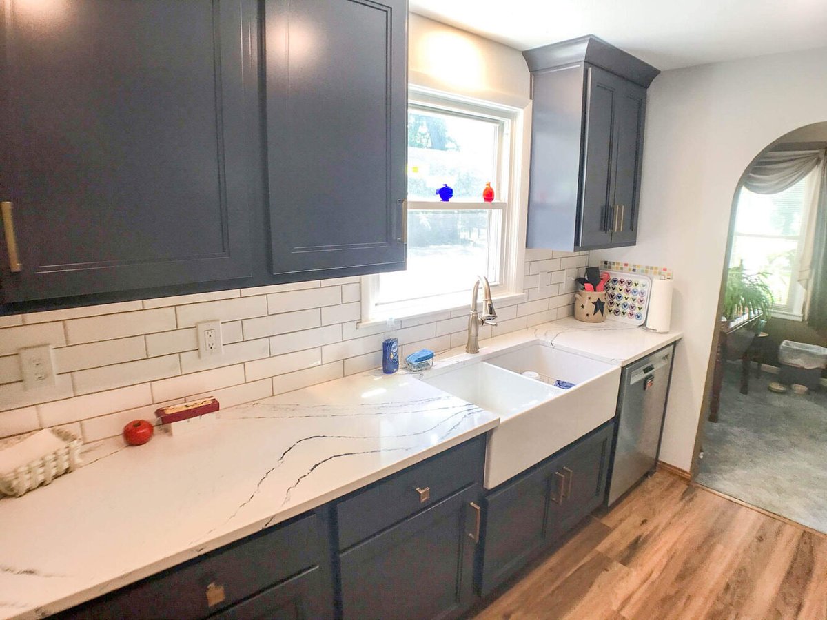 close-up of kitchen remodel featuring quartz countertops, farmhouse sink, and shaker cabinets by Odd Fellows Contracting in Williamston, MI