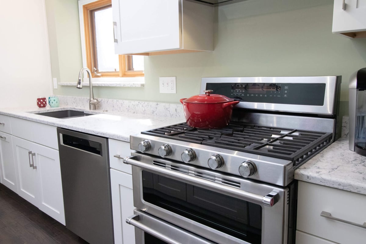 kitchen remodel by Odd Fellows Contracting in Haslett MI with stainless steel range and quartz countertops