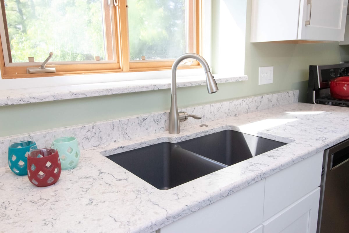 kitchen sink and countertop detail by Odd Fellows Contracting in Haslett MI with undermount sink and quartz surface