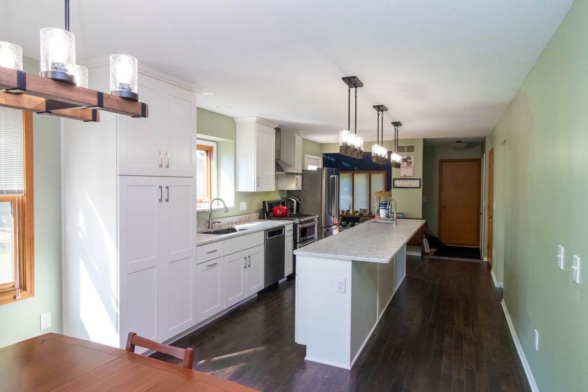 remodeled kitchen by Odd Fellows Contracting in Haslett MI with large island and pendant lighting