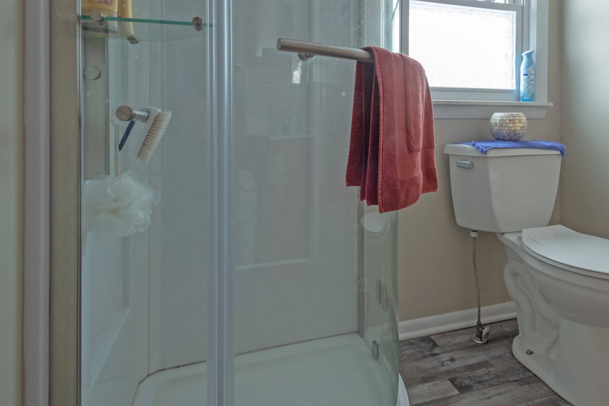 bathroom remodel with glass shower and toilet by Odd Fellows Contracting in Eaton Rapids, MI