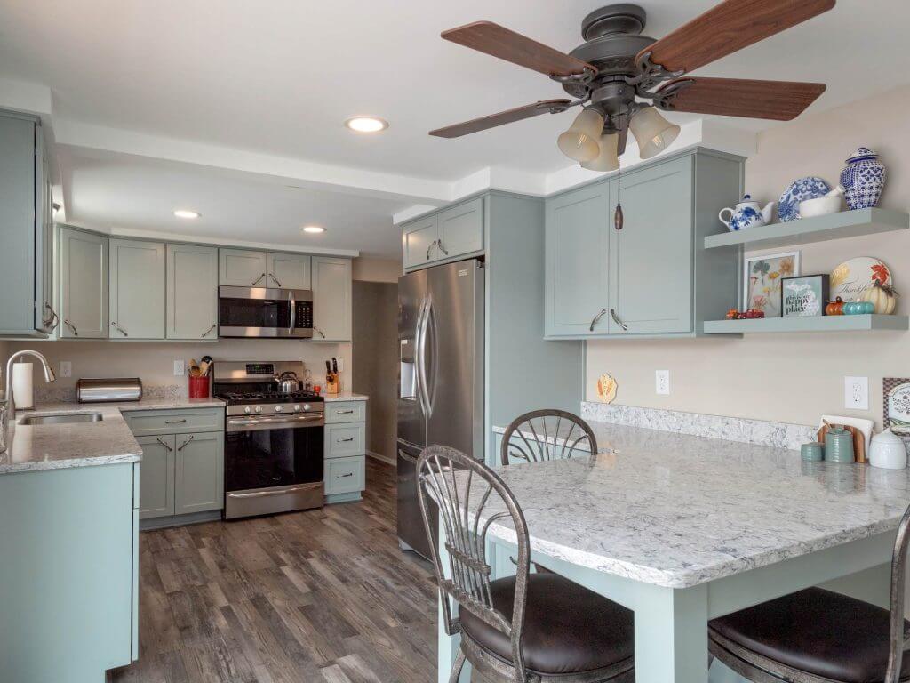 completed kitchen remodel with sage cabinets and peninsula by Odd Fellows Contracting in Eaton Rapids, MI