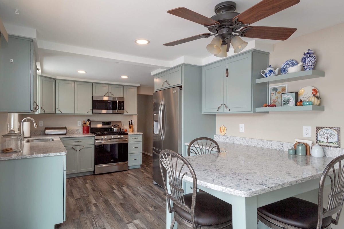 modern kitchen remodel with marble countertops and stainless appliances by Odd Fellows Contracting in Eaton Rapids, MI