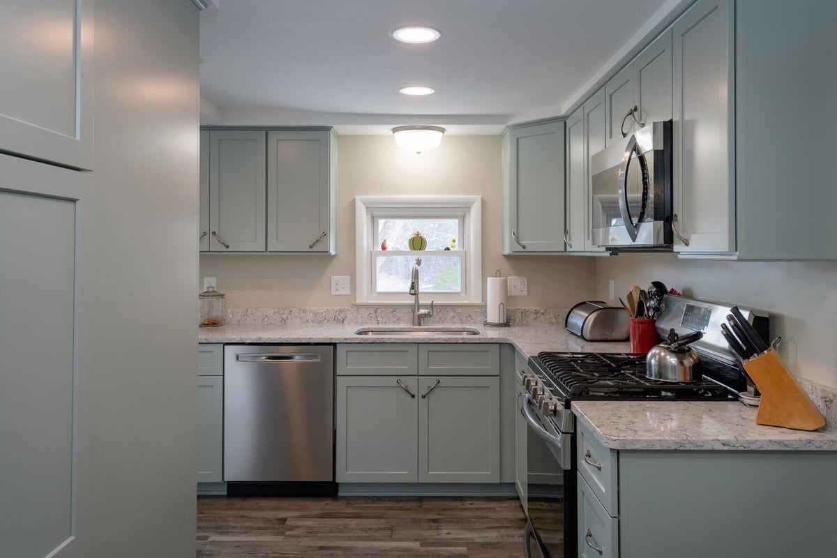 remodeled kitchen layout with sink window and custom cabinetry by Odd Fellows Contracting in Eaton Rapids, MI