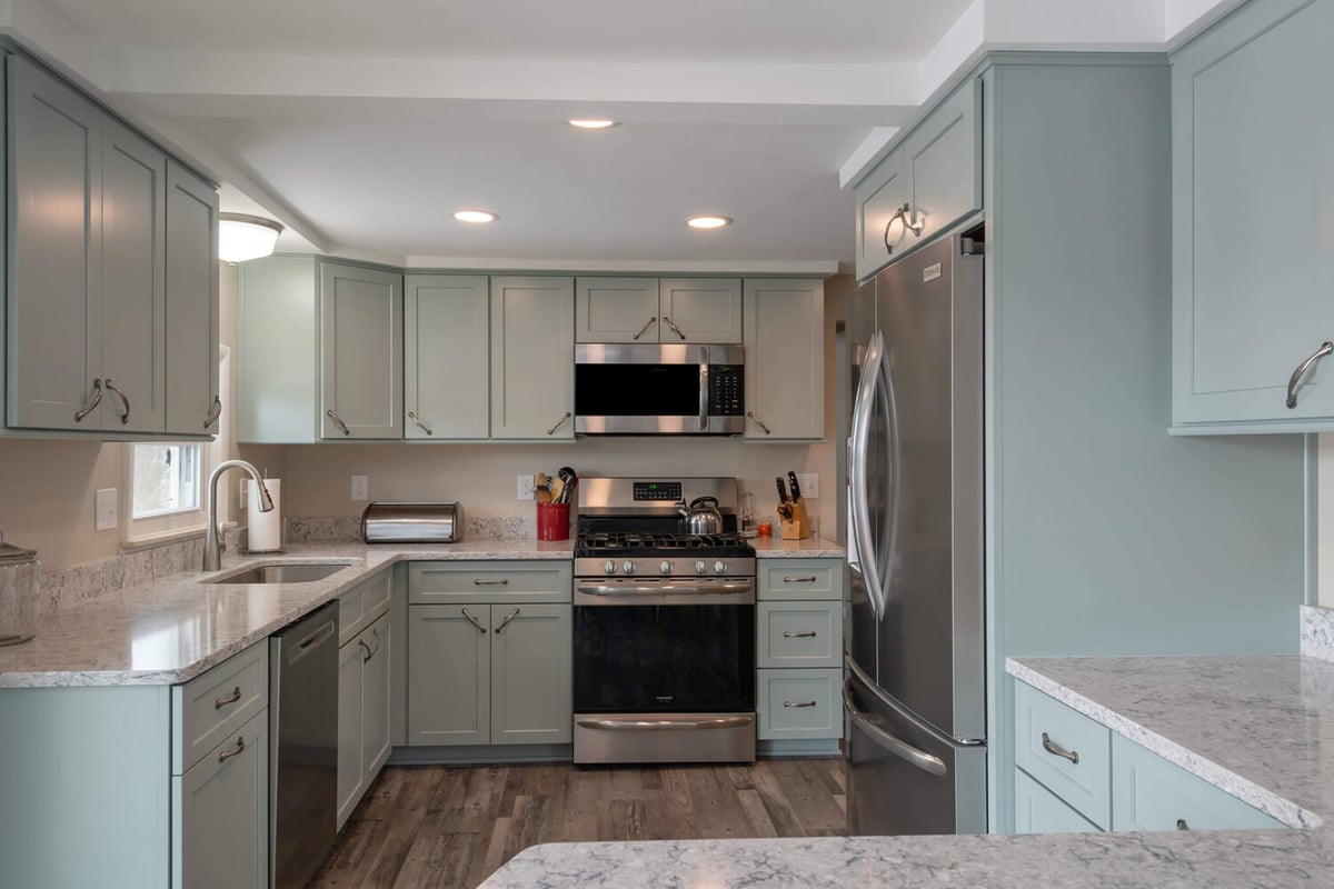 updated kitchen design with recessed lighting and custom cabinets by Odd Fellows Contracting in Eaton Rapids, MI