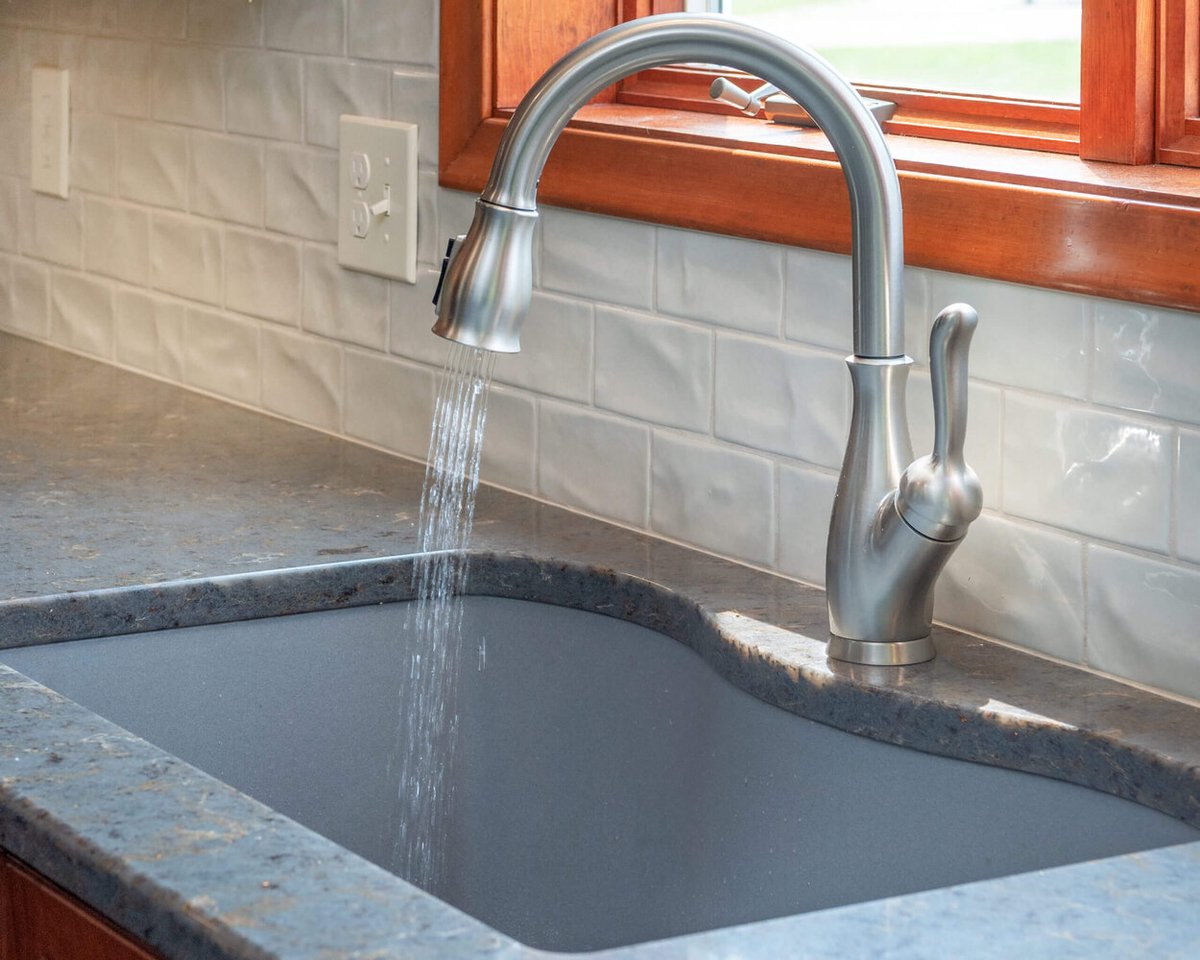 undermount kitchen sink with modern faucet in remodel by Odd Fellows Contracting in Grand Ledge, MI