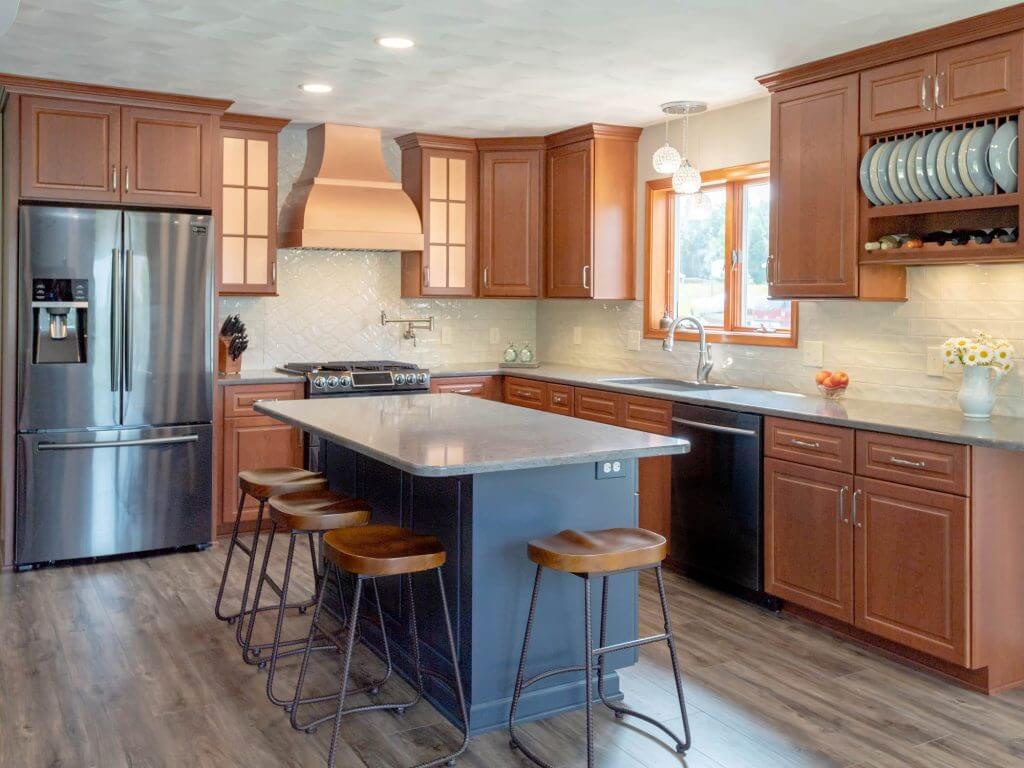 updated kitchen design with stainless appliances and island by Odd Fellows Contracting in Grand Ledge, MI