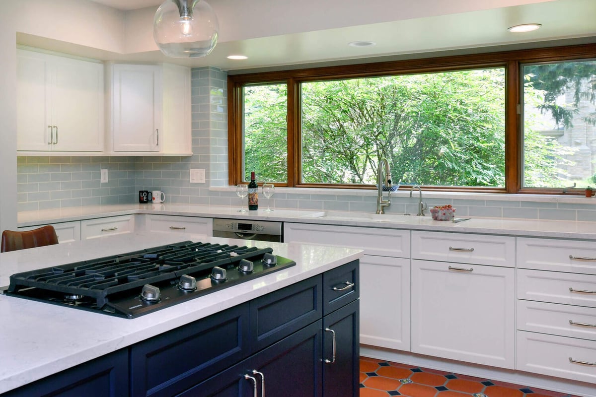 remodeled kitchen with large window and modern cabinetry by Odd Fellows Contracting in Okemos, MI