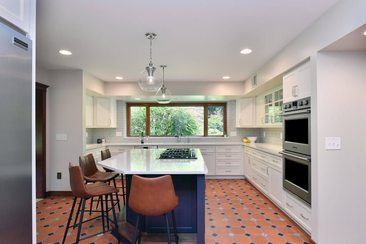 wide view of kitchen remodel with large island and custom cabinetry by Odd Fellows Contracting in Okemos, MI