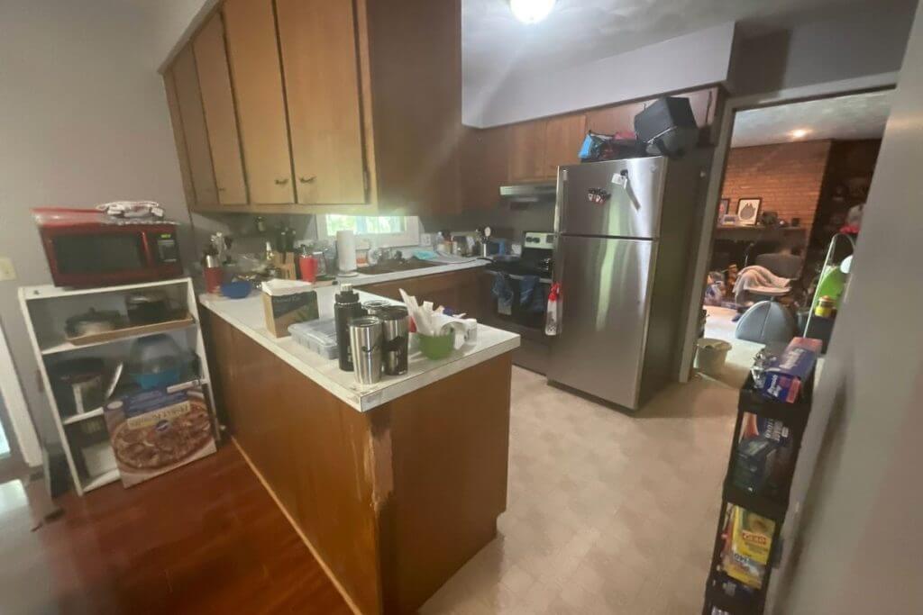 Existing kitchen before renovation by Odd Fellows Contracting in West Lansing, MI with wood cabinets and compact layout.