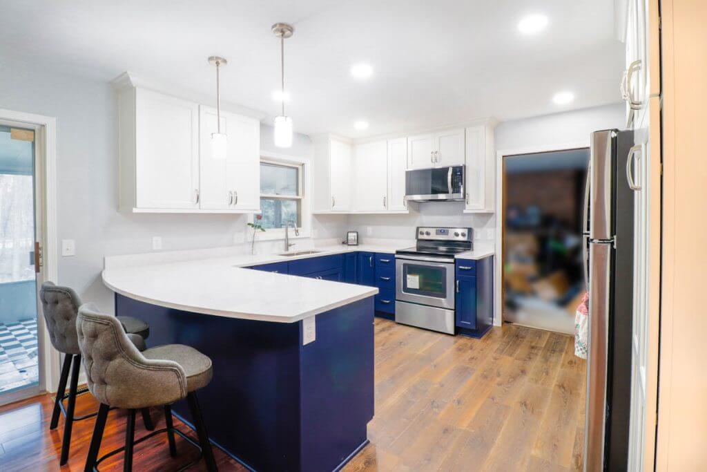 Kitchen peninsula detail in a West Lansing, MI remodel by Odd Fellows Contracting with seating and quartz surface.