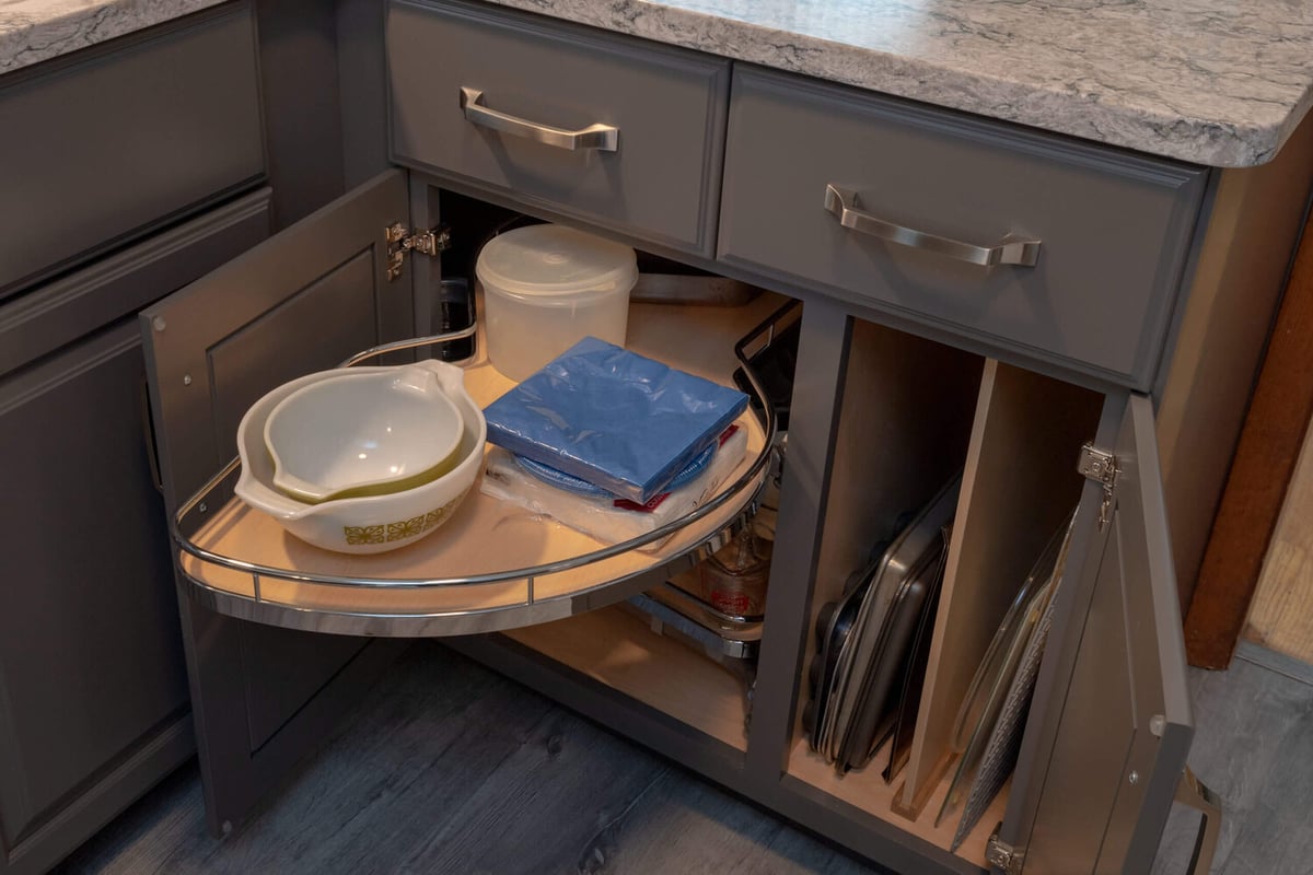 custom kitchen cabinet storage with lazy susan organizer by Odd Fellows Contracting in Lansing, MI