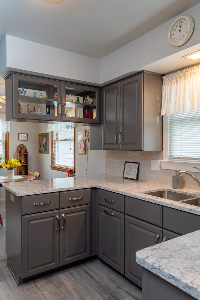 finished kitchen remodel with gray cabinets and quartz countertops by Odd Fellows Contracting in Lansing, MI