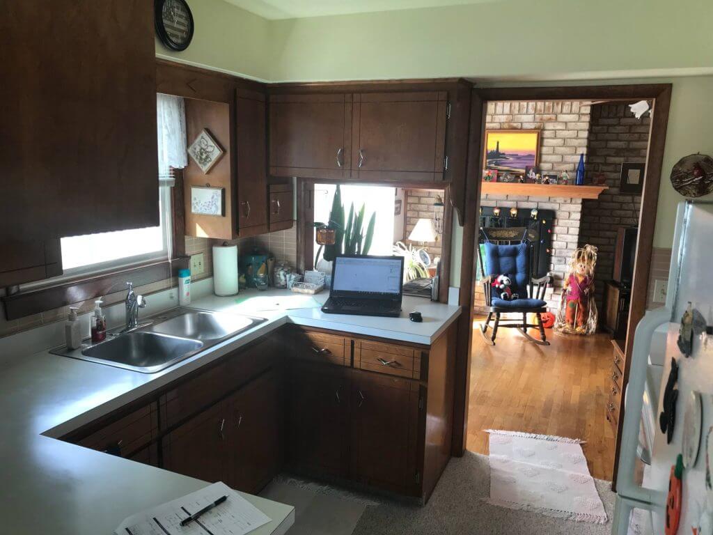 outdated kitchen with wood cabinets before remodel by Odd Fellows Contracting in Lansing, MI