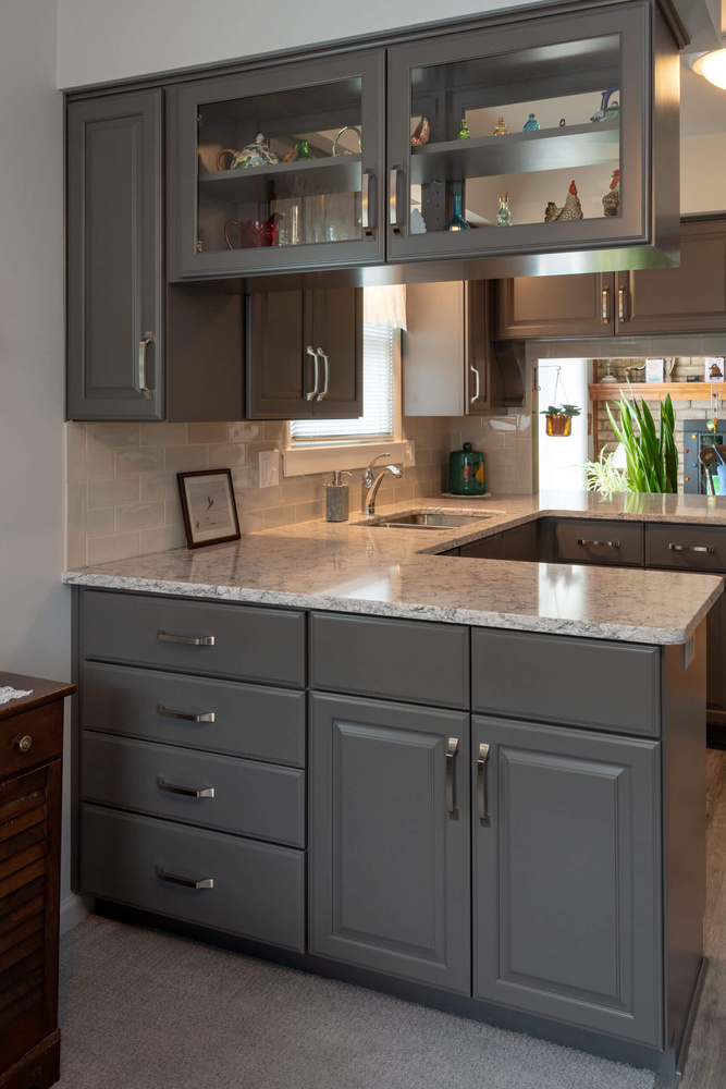 remodeled kitchen peninsula with quartz countertop and storage drawers by Odd Fellows Contracting in Lansing, MI