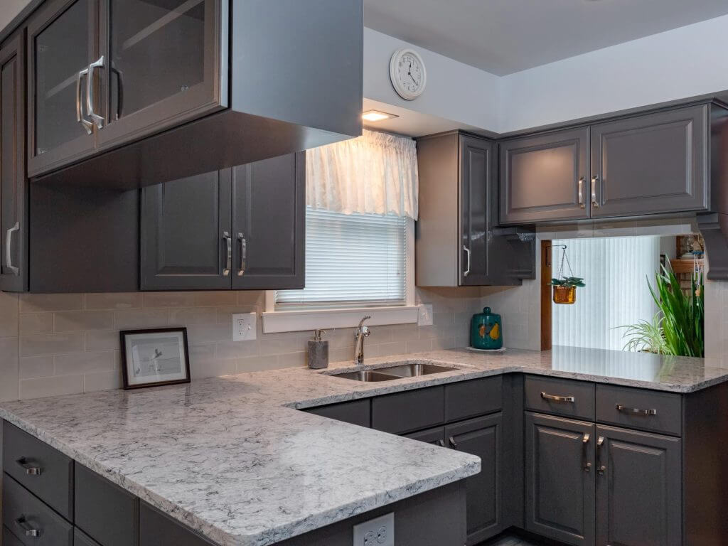 updated kitchen renovation with subway tile backsplash and modern cabinets by Odd Fellows Contracting in Lansing, MI