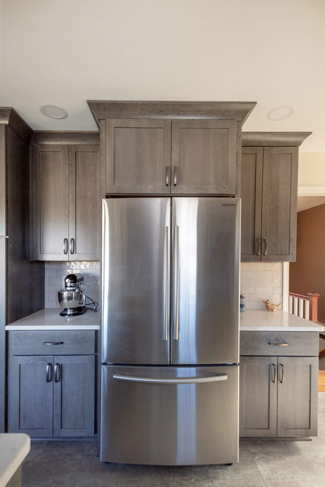 kitchen remodel with stainless steel refrigerator and gray cabinets by Odd Fellows Contracting in Onondaga, MI