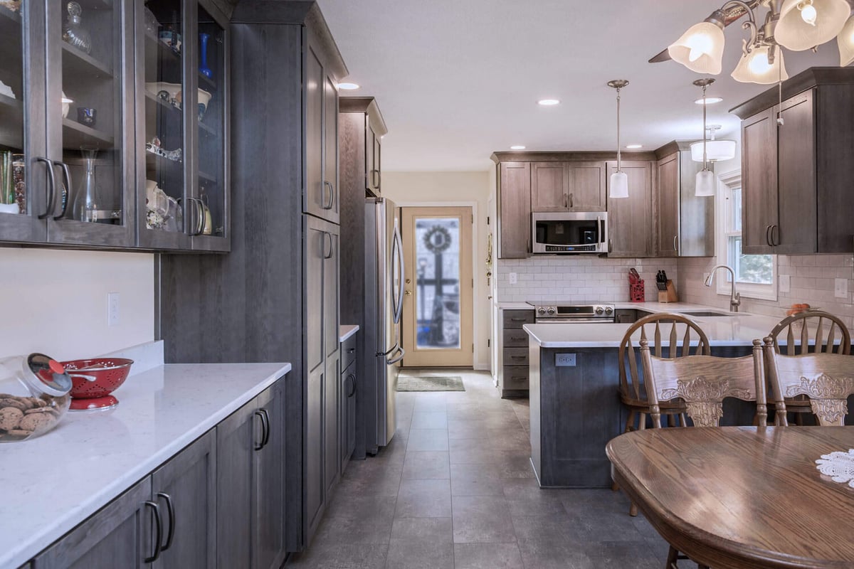 modern kitchen remodel with gray cabinets and quartz island by Odd Fellows Contracting in Onondaga, MI