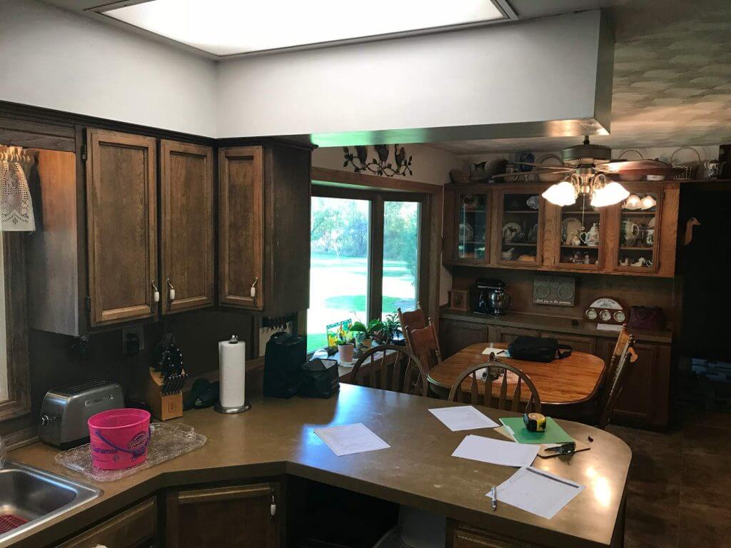 original kitchen before remodel with dark wood cabinets by Odd Fellows Contracting in Onondaga, MI