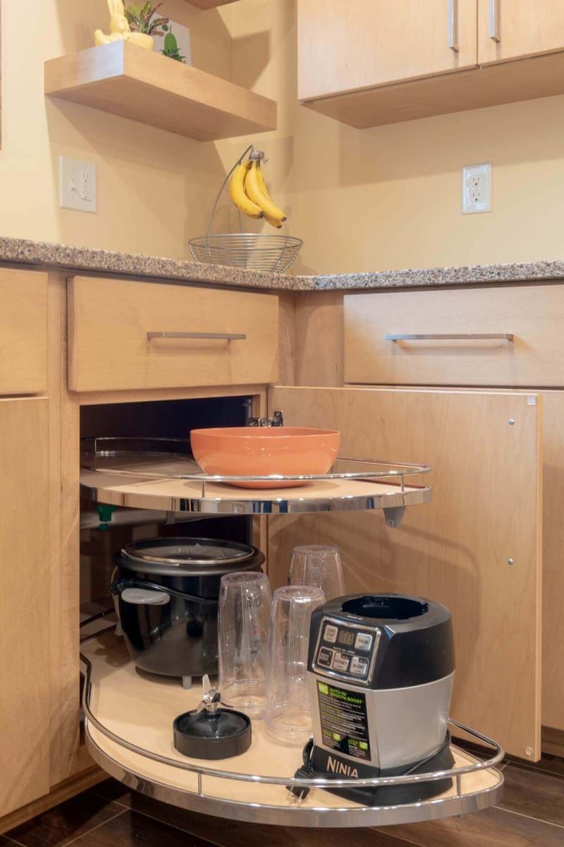 Corner kitchen cabinet with pull-out storage system installed during East Lansing MI kitchen remodel by Odd Fellows Contracting