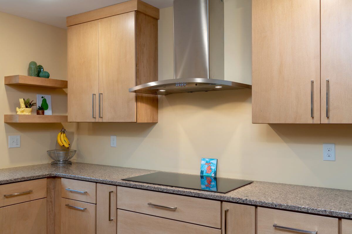 custom kitchen cabinets and cooktop area by Odd Fellows Contracting in East Lansing MI