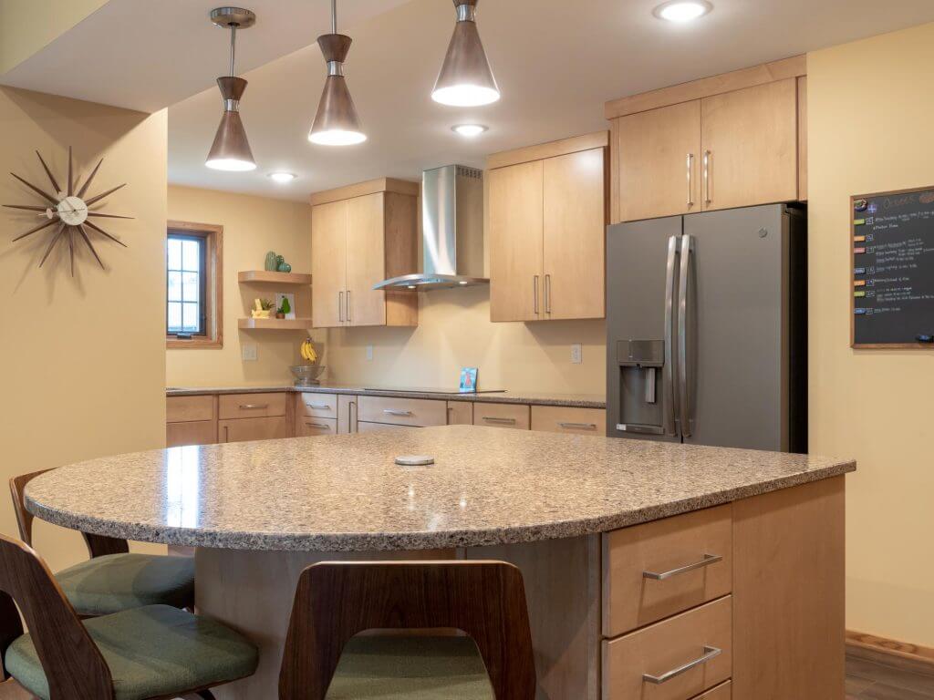 updated kitchen interior with new countertops and lighting by Odd Fellows Contracting in East Lansing Michigan