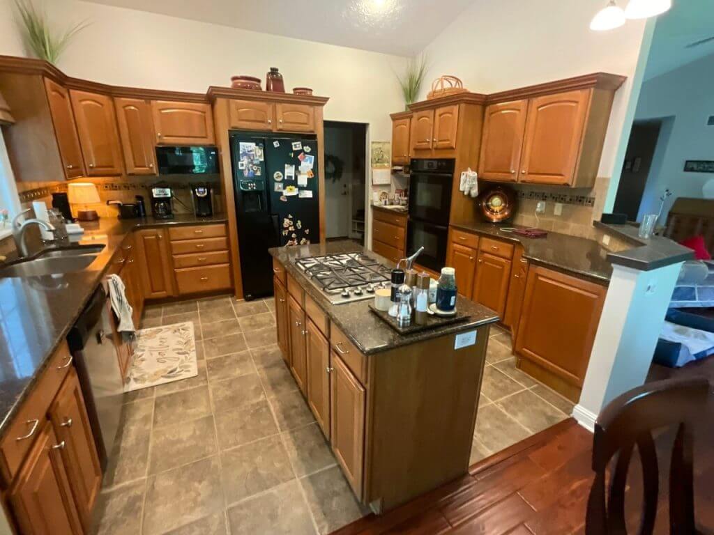 outdated kitchen prior to renovation by Odd Fellows Contracting in Candlewood Estates, MI with wood cabinetry and tile flooring