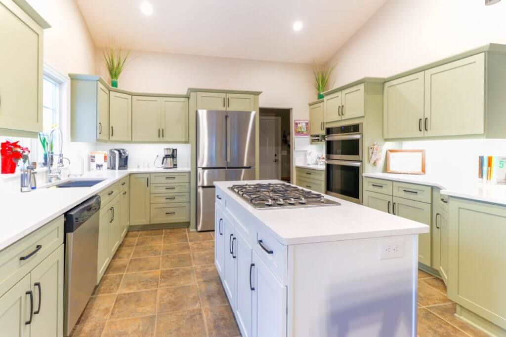 renovated kitchen in Candlewood Estates, MI by Odd Fellows Contracting featuring quartz countertops and stainless appliances