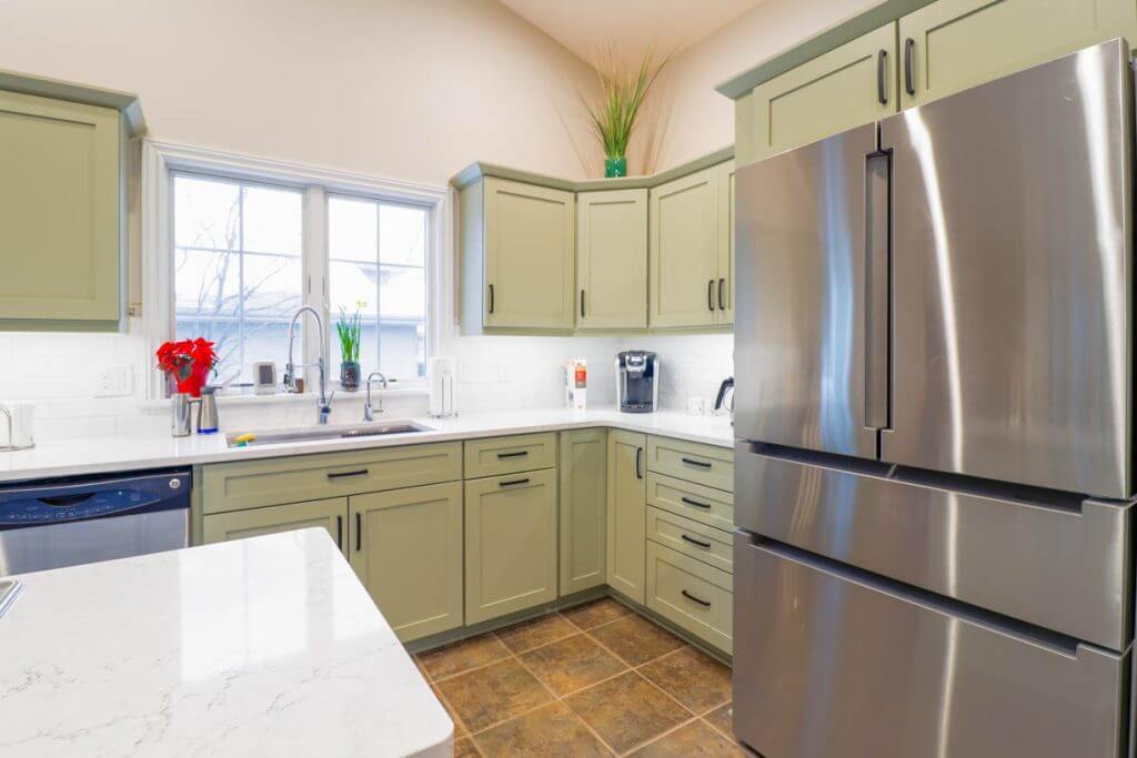 stainless steel refrigerator and cabinetry from kitchen remodel by Odd Fellows Contracting in Candlewood Estates, MI