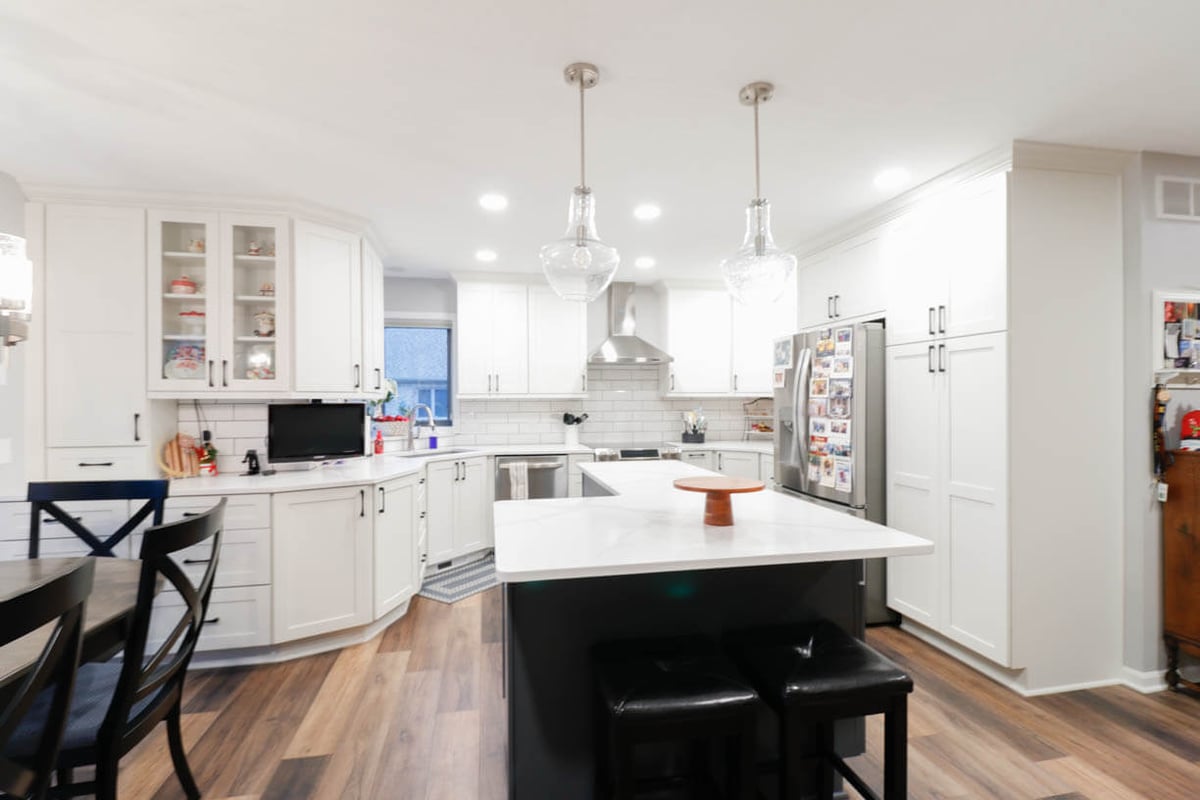 bright kitchen remodel by Odd Fellows Contracting in Walmar Estates, MI with white cabinetry and oversized island