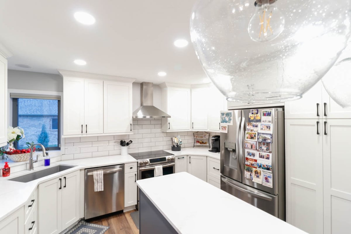 finished kitchen renovation by Odd Fellows Contracting in Walmar Estates, MI with white cabinets and quartz counters
