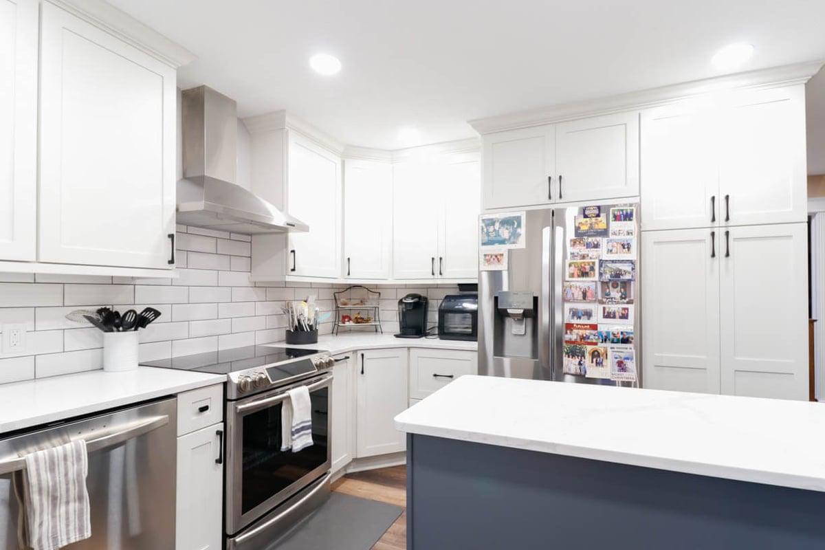 remodeled kitchen corner with stainless range and hood by Odd Fellows Contracting in Walmar Estates, MI