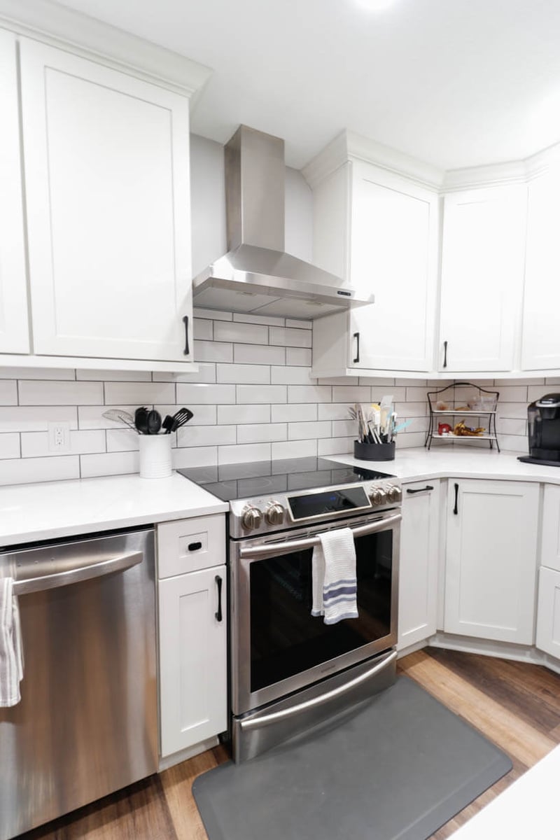 stainless steel range and vent hood from kitchen remodel by Odd Fellows Contracting in Walmar Estates, MI