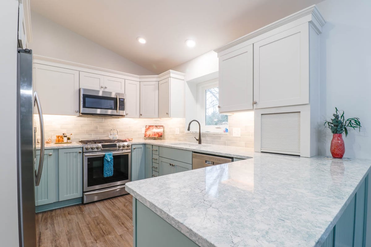close-up of quartz countertop and beadboard peninsula from kitchen remodel by Odd Fellows Contracting in Williamston, MI