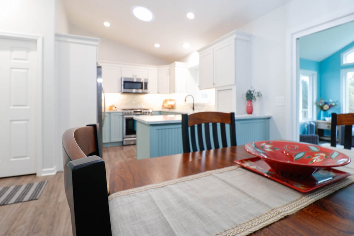 completed kitchen remodel with updated lighting and flooring in Williamston, MI by Odd Fellows Contracting