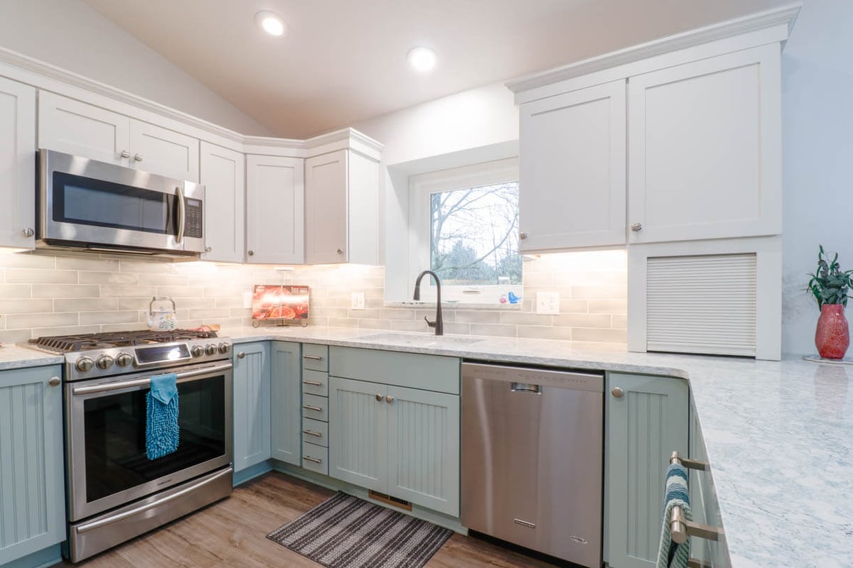 remodeled kitchen corner with stainless steel range and microwave by Odd Fellows Contracting in Williamston, MI