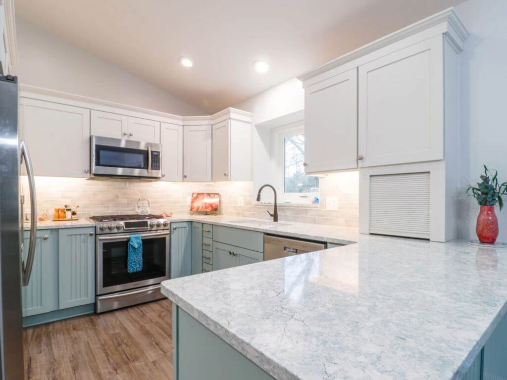 updated kitchen design by Odd Fellows Contracting in Williamston, MI featuring quartz countertops and subway tile backsplash