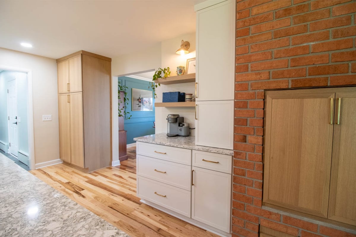 built-in cabinetry and brick fireplace detail from kitchen remodel by Odd Fellows Contracting in Hiawatha Lakes, Okemos, MI