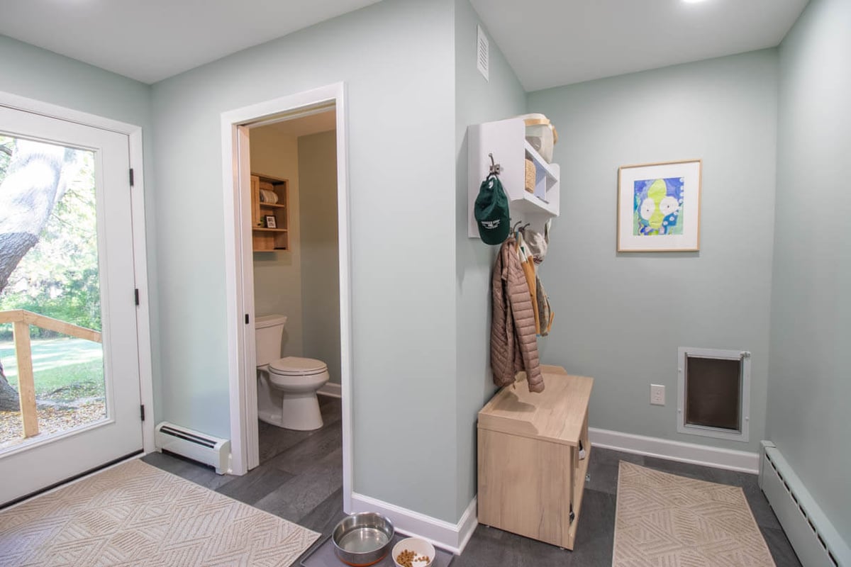 mudroom storage and half bath addition by Odd Fellows Contracting in Hiawatha Lakes, Okemos, MI with built-in bench and wall hooks