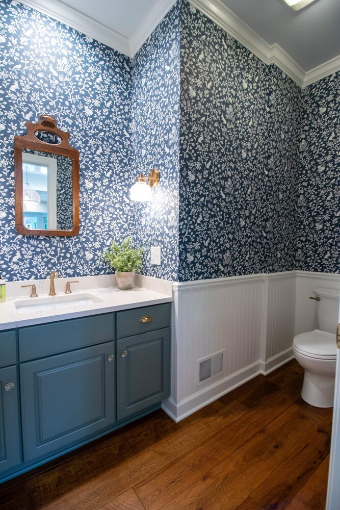 blue vanity and patterned wallpaper from Okemos, MI renovation by Odd Fellows Contracting