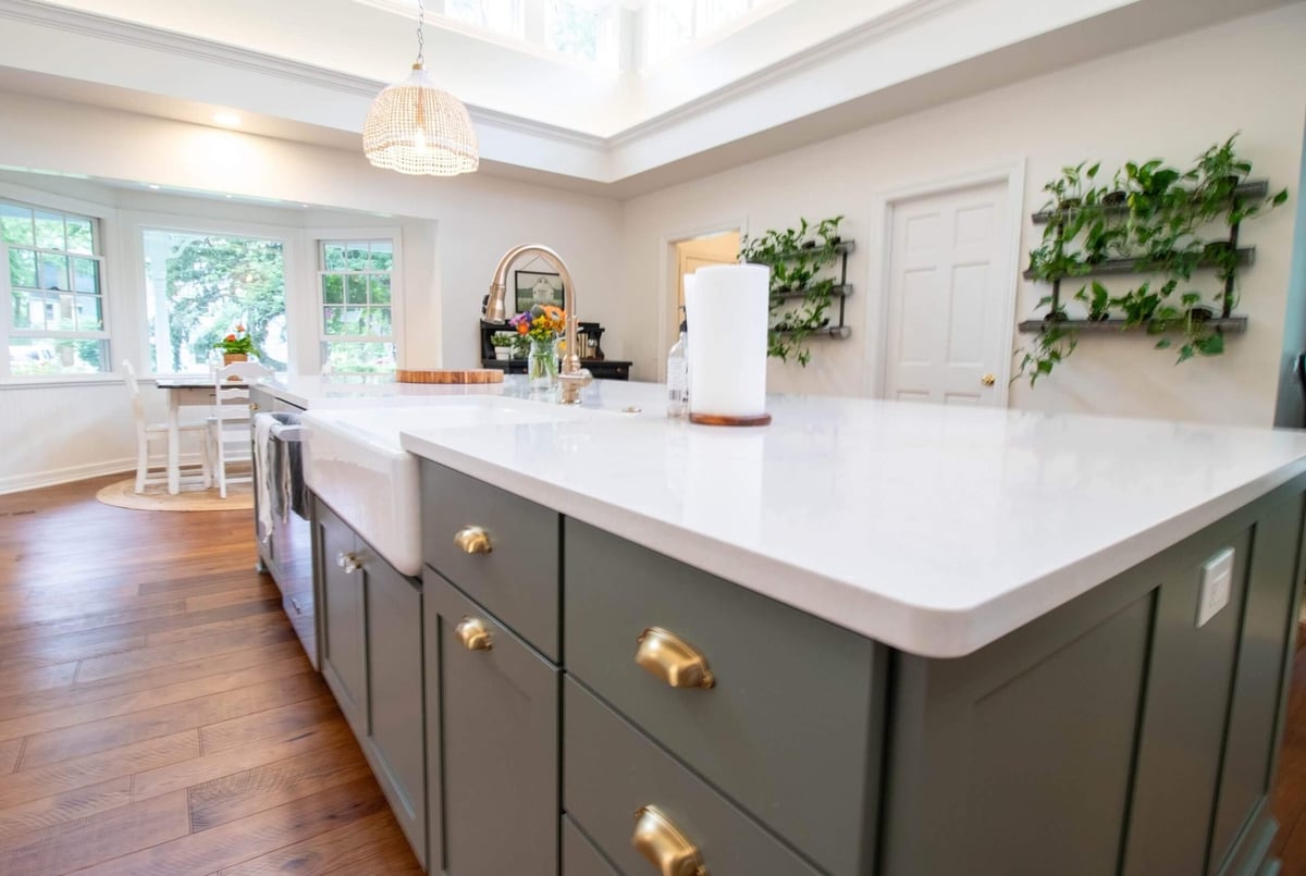 large quartz island with farmhouse sink from kitchen remodel by Odd Fellows Contracting in Okemos, MI