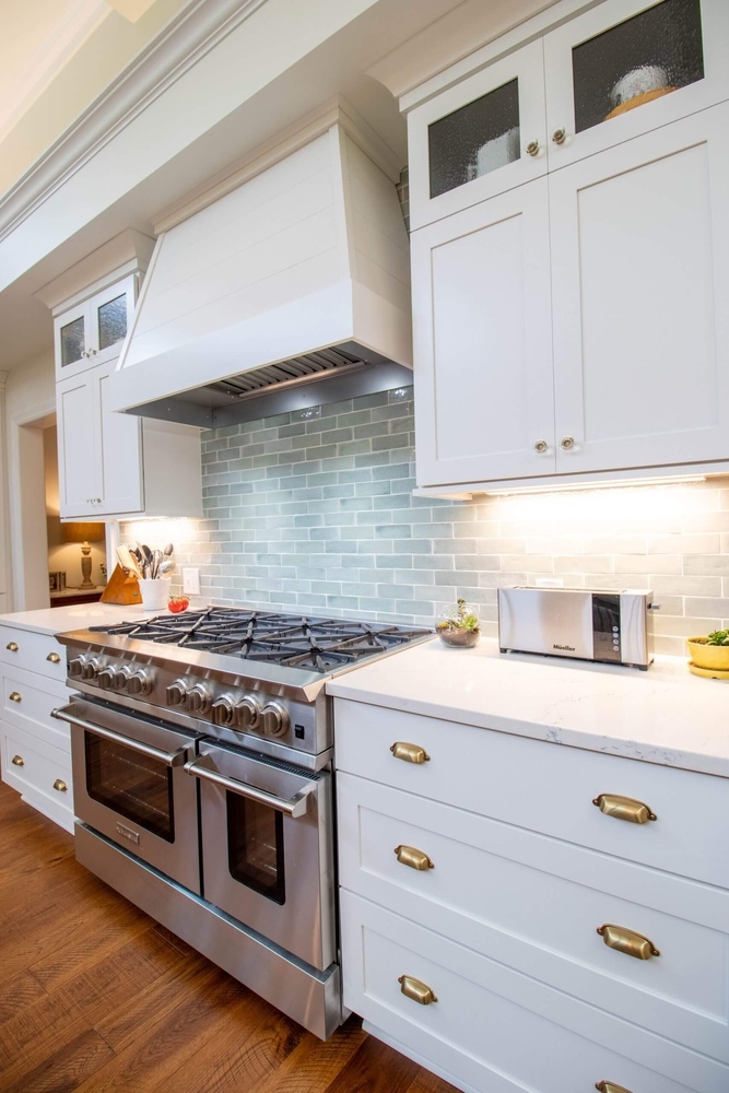 professional gas range and tile backsplash from kitchen remodel by Odd Fellows Contracting in Okemos, MI