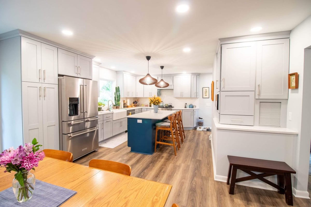 white cabinetry and blue island in Okemos, MI custom home by Odd Fellows Contracting