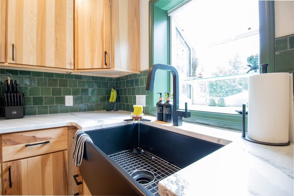 farmhouse sink with green tile backsplash in Okemos, MI kitchen remodel by Odd Fellows Contracting