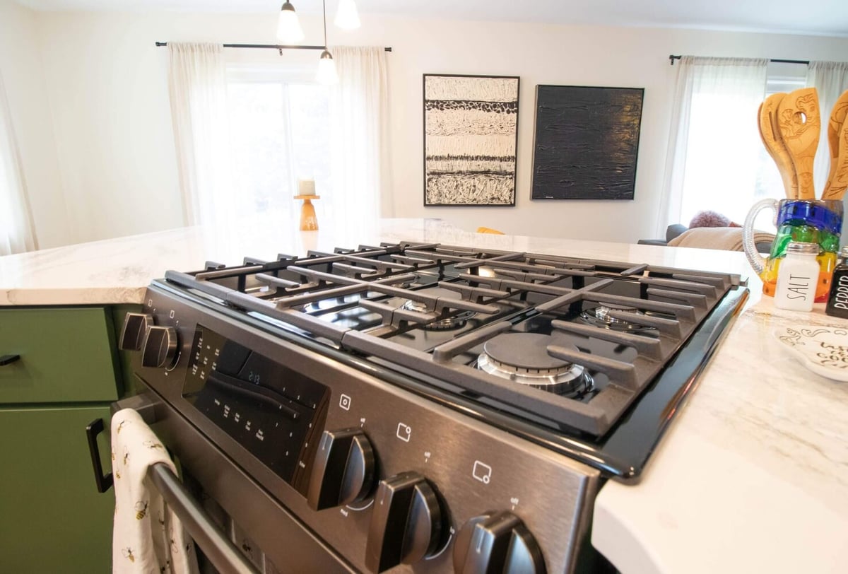 gas cooktop installed in quartz island during Okemos, MI kitchen remodel by Odd Fellows Contracting