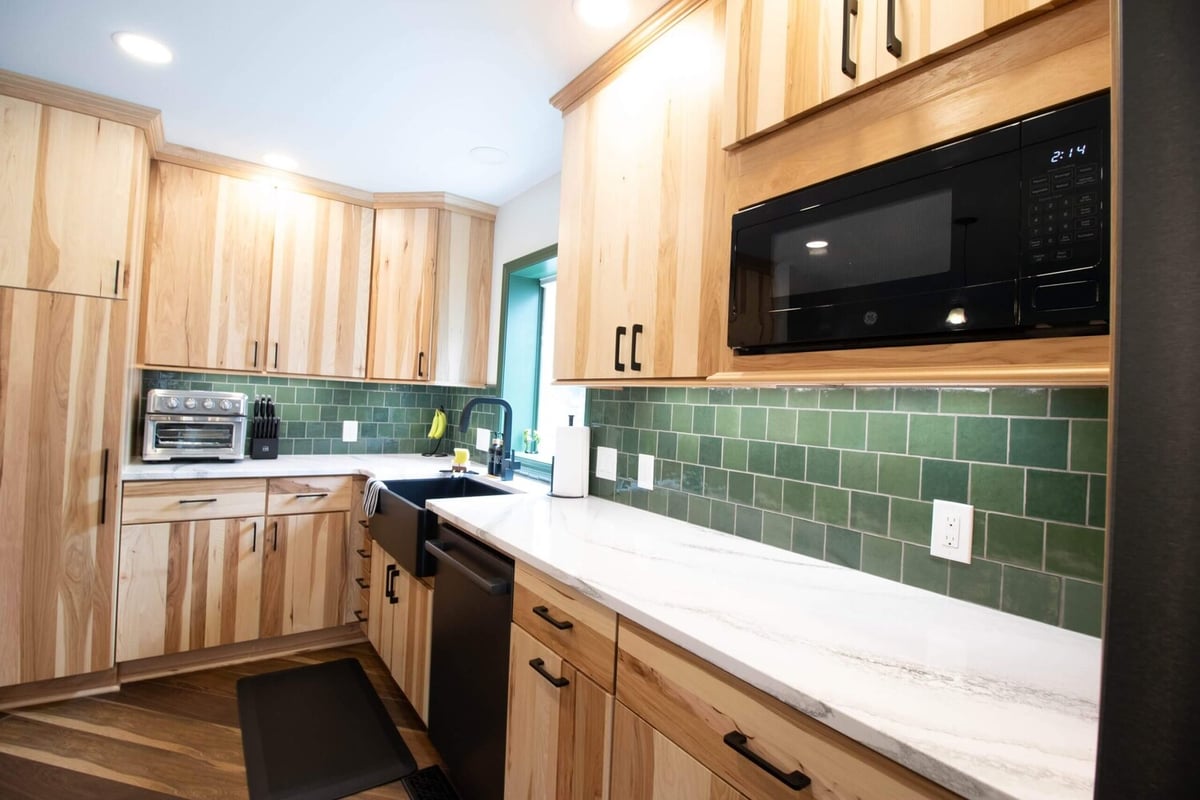 microwave and green subway tile backsplash in Okemos, MI kitchen remodel by Odd Fellows Contracting