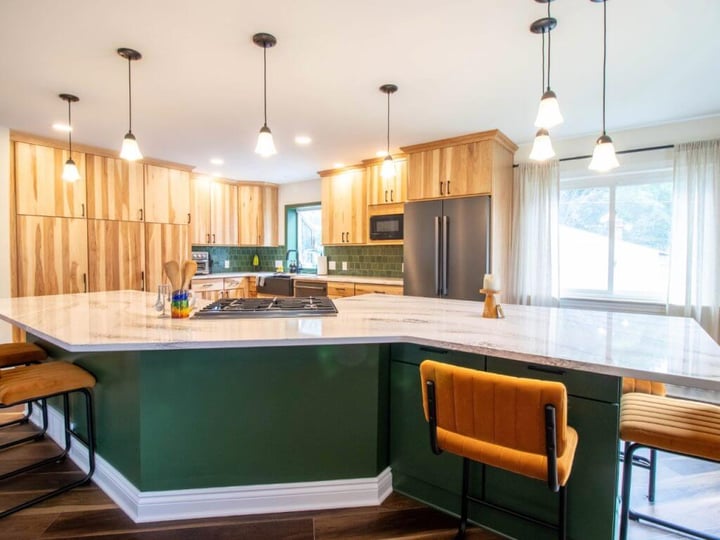 updated kitchen featuring quartz waterfall island in Okemos, MI by Odd Fellows Contracting