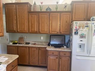 before kitchen remodel by Odd Fellows Contracting in Williamston, MI with original wood cabinets and laminate counters